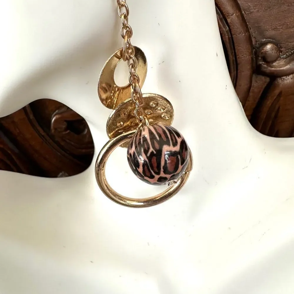 Gold tone charm drop earrings